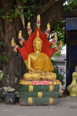 Golden Buddha sitting on a coiled cobra. Vientiane, Laos