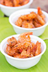 Fried Shrimp with white bowl on green banana leaf.