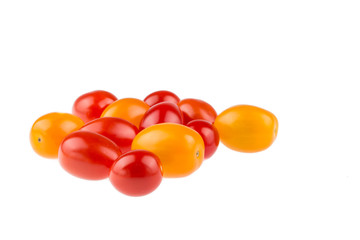 Yellow and red cherry tomatoes on white background