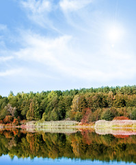 Fototapeta premium Lake in autumn forest