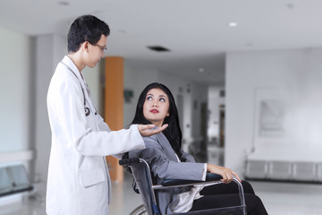 Disabled woman and doctor talking in the hospital