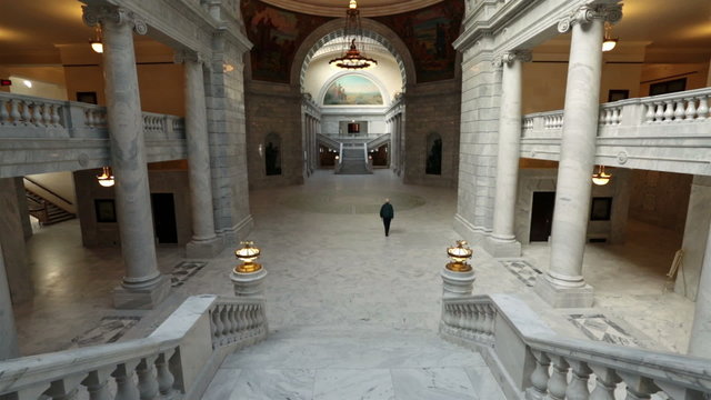 Utah State Capital man walks through rotunda building HD 4756