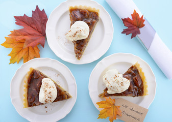 Traditional Thanksgiving Pecan Pie on Pale Blue Wood.