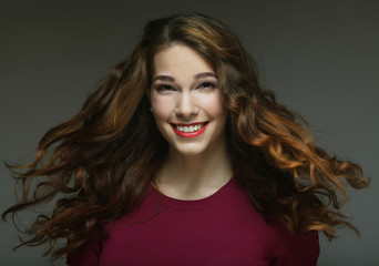 Fototapeta premium Young happy woman with wind in hair 