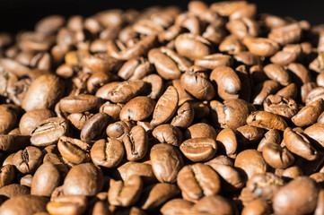 Background of roasted coffee beans lit by the sun