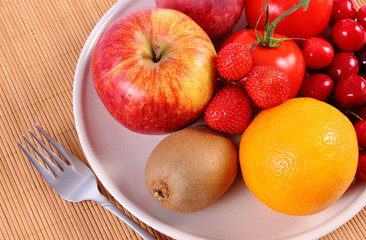 Naklejka na ściany i meble Fresh fruits and vegetables on plate, healthy nutrition