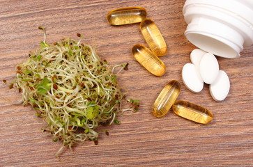 Fototapeta na wymiar Alfalfa and radish sprouts with tablets supplements, healthy nutrition