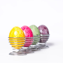 Multicolored chicken eggs in egg holder