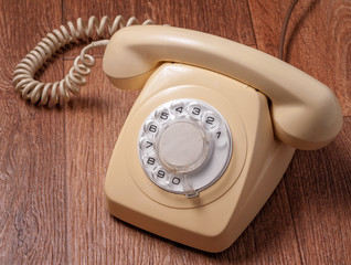 Retro telephone on wooden table in front gradient background