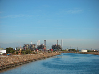 Fototapeta na wymiar industrial factory in the distance along peaceful river
