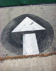 painted arrow on concrete parking lot ground