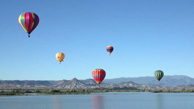 Colorful hot air balloon flight over rural lake 4K 059
