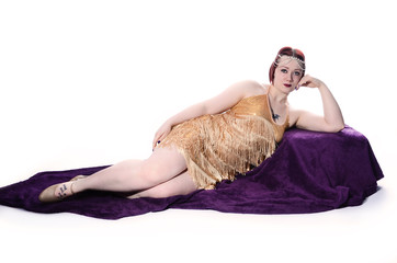 1920s Flapper girl in gold dress, relaxing