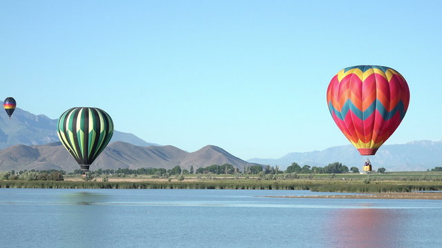Hot air balloon touches water valley lake 4K 061