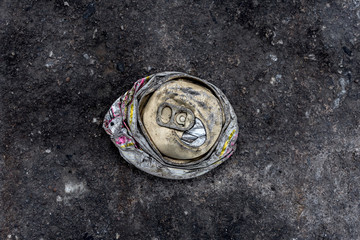 crushed can on the road