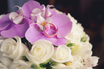 Wedding rings on wedding bouquet