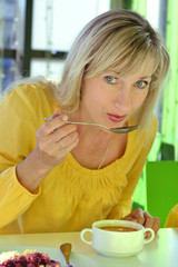 The woman eats in cafe
