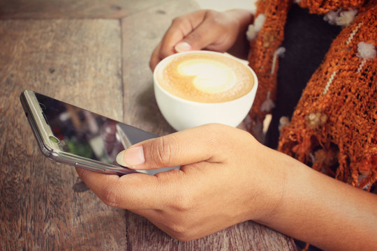 Selfie of woman drinking coffee cup with smart phone