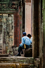 Obraz na płótnie Canvas Two man sitting between stone doors