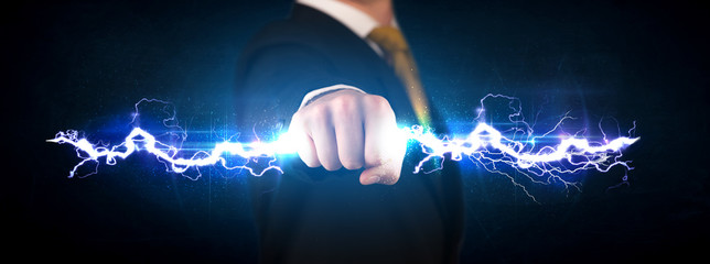 Business man holding electricity light bolt in his hands