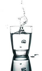 pouring water on a glass on white background