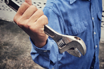 Man with adjustable wrench tool