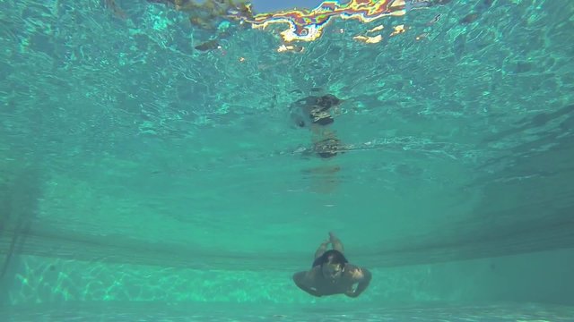 Man swimming. Shot from underwater.