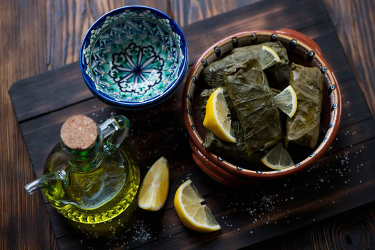 Eastern dolmades served with lemon and olive oil, studio shot