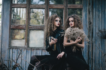 Two vintage witches gathered eve of Halloween