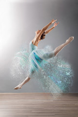 Beautiful female ballet dancer jump, grey background