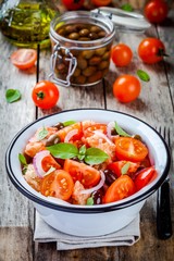 panzanella: Italian salad with tomatoes, ciabatta, olives, red onion and basil