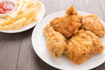 fried chicken and french fries on a wooden background