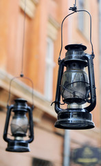 Kerosene lamp on the background of the old house, the old street