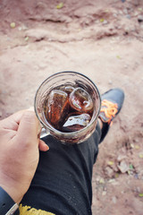 Selfie of hand with cola drink