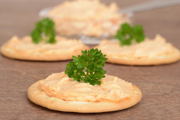 cracker with salmon pate on wood