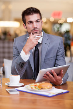 young businessman in the coffee break working on his laptop