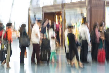 Blurred airport, traveler silhouettes in motion blur
