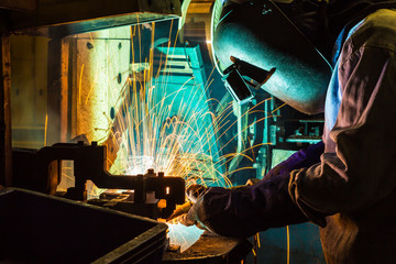 skilled working factory welder.