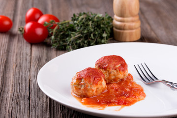 meatballs in tomato sauce on white plate