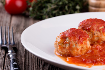 meatballs in tomato sauce on white plate