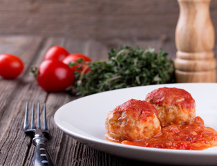 meatballs in tomato sauce on white plate