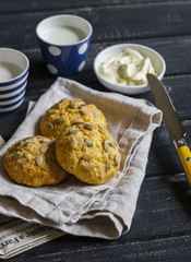 homemade pumpkin buns on the grey napkin on a dark wooden surface