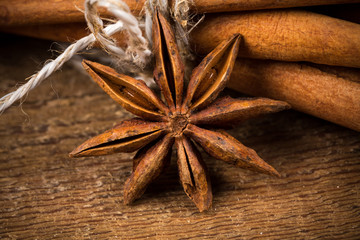 Close up of cinnamon sticks and star anise on wood