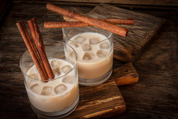 Irish cream liqueur in a glass with ice and cinnamon