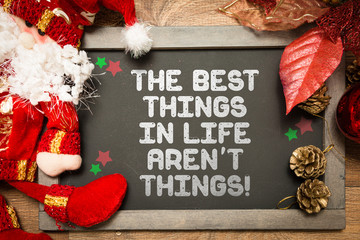 Blackboard with the text: The Best Things In Life Aren't Things in a christmas conceptual image