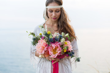 girl with a wedding bouquet boho style