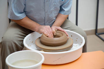potter working on ceramic jug