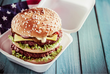 Double-decker cheeseburger on a sesame roll