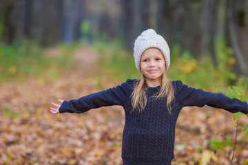 Adorable little girl outdoors at beautiful autumn day