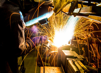 MIG welder uses torch to make sparks during manufacture of metal equipment.